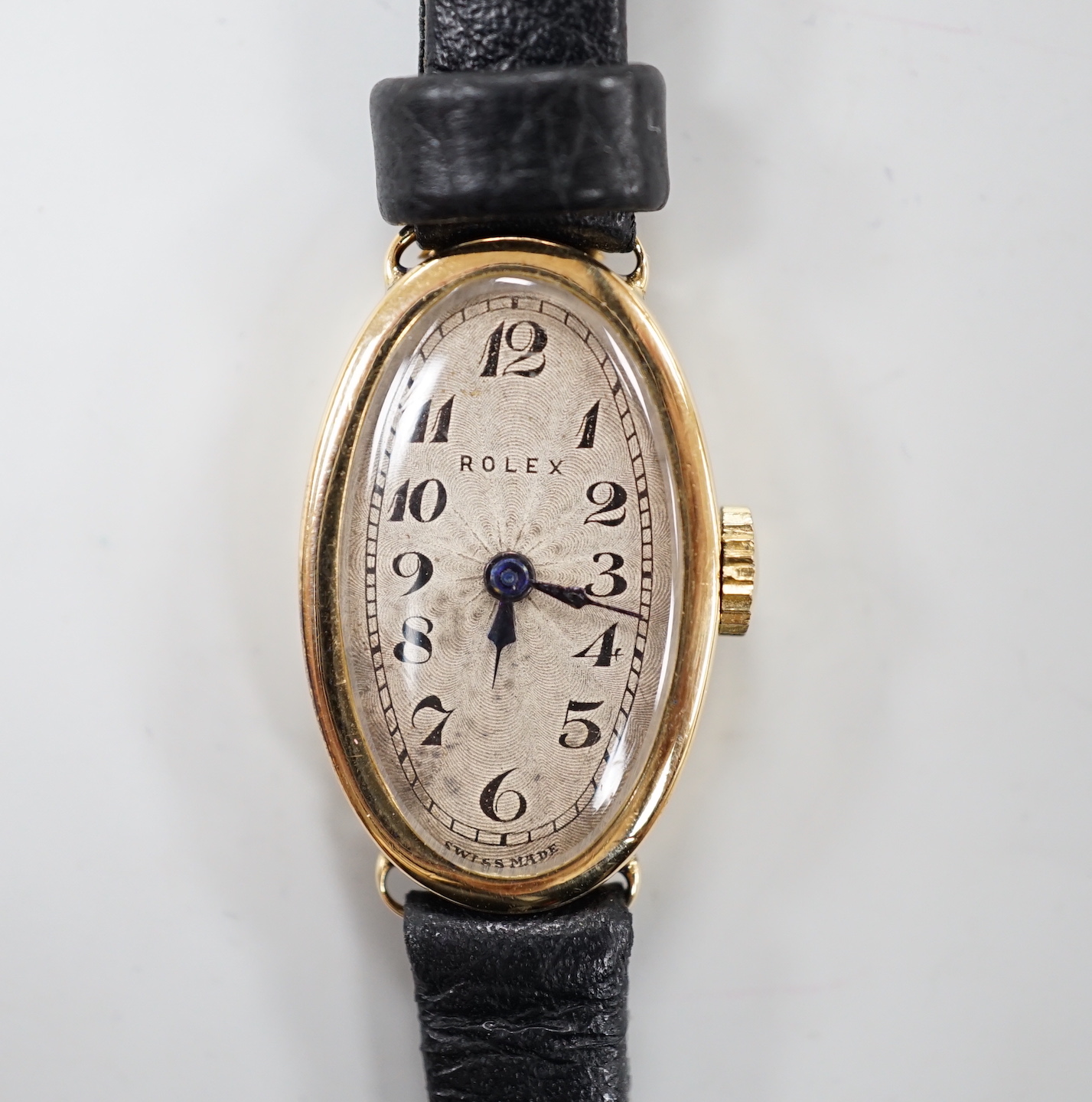 A lady's 1930's 18ct gold oval Rolex manual wind wrist watch, with Roman dial and Rolex Prima movement, with engraved inscription and associated strap, with service receipt.